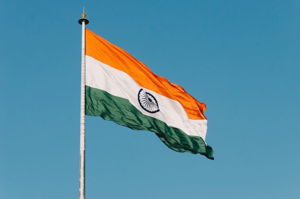India tariffs Indian flag waving in the wind against blue sky background during trade conflict with Trump tariffs and sanctions over Russian ties