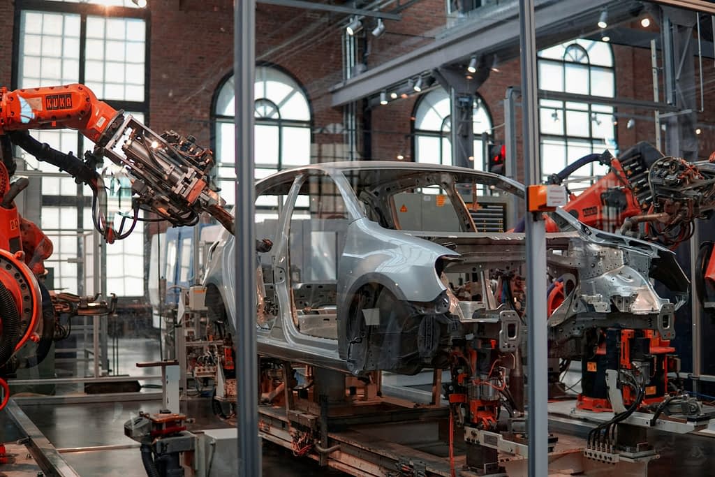 Car factory Automotive assembly line with industrial robots in German car factory - symbol of German industry crisis and job losses