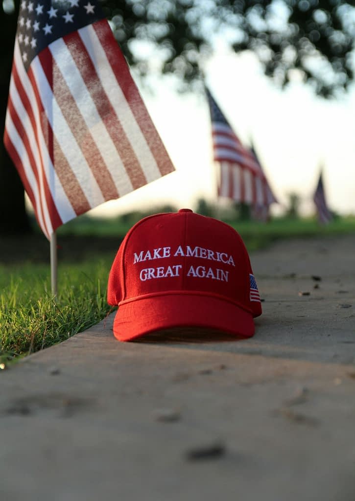 America Tariffs Red Make America Great Again hat with American flags symbolizing Trump's trade policy toward EU and new tariffs