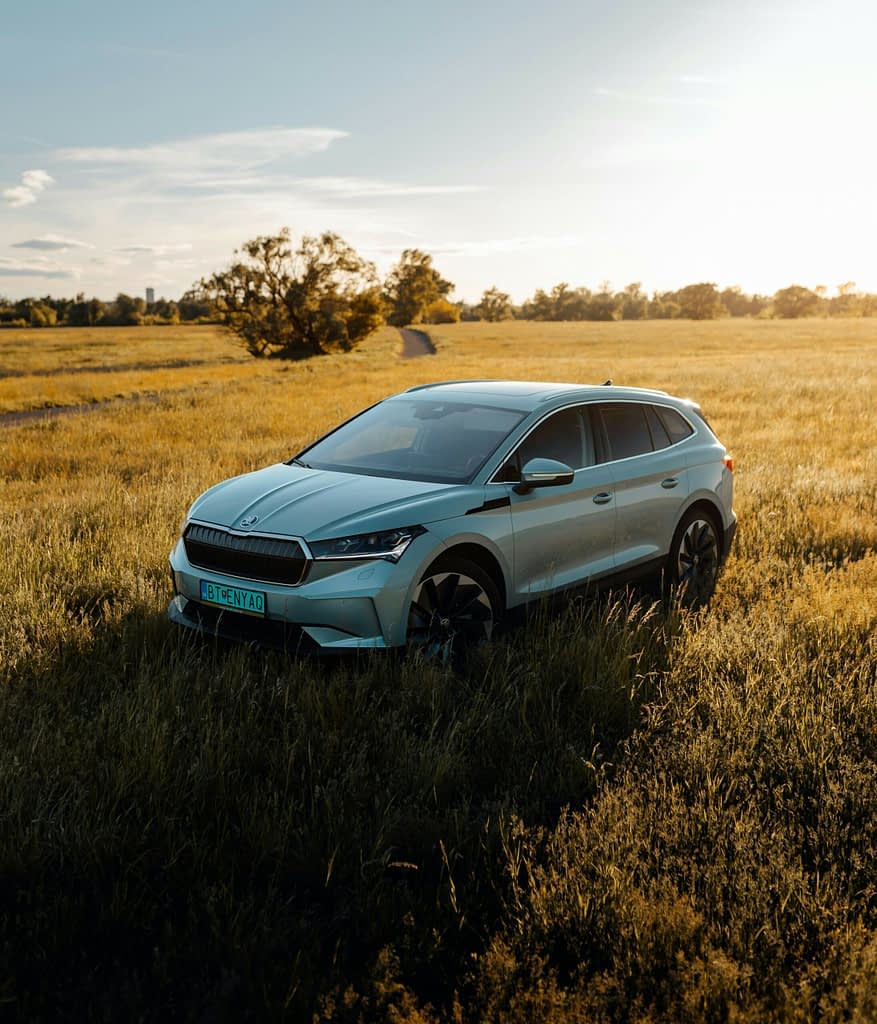 Škoda Enyaq electric vehicle in a field at sunset represents the most successful model with record 8.5 percent margin